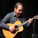 Photo of Roberto Silva, Musician from Banda Aurora, playing guitar
